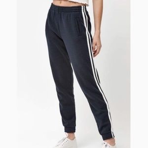 Navy blue sweatpants. White stripes down sides.